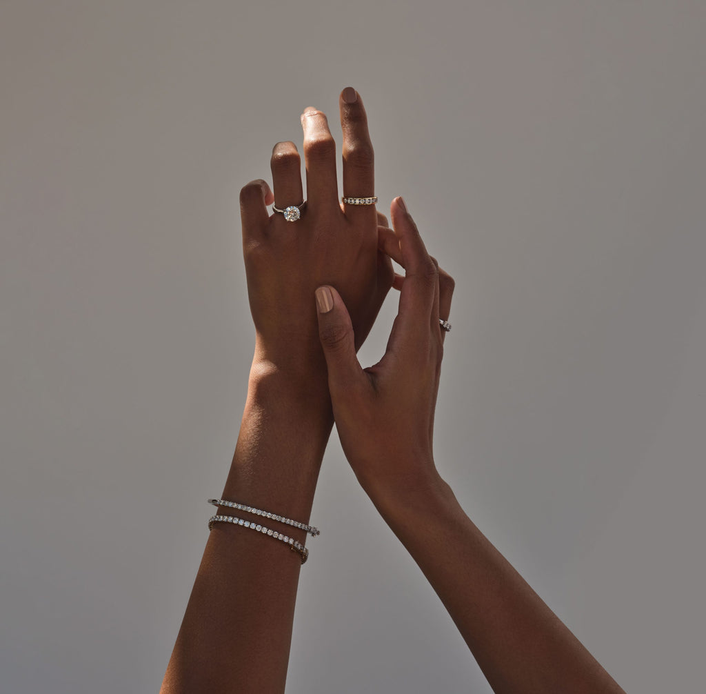 raising hands wearing jewellery