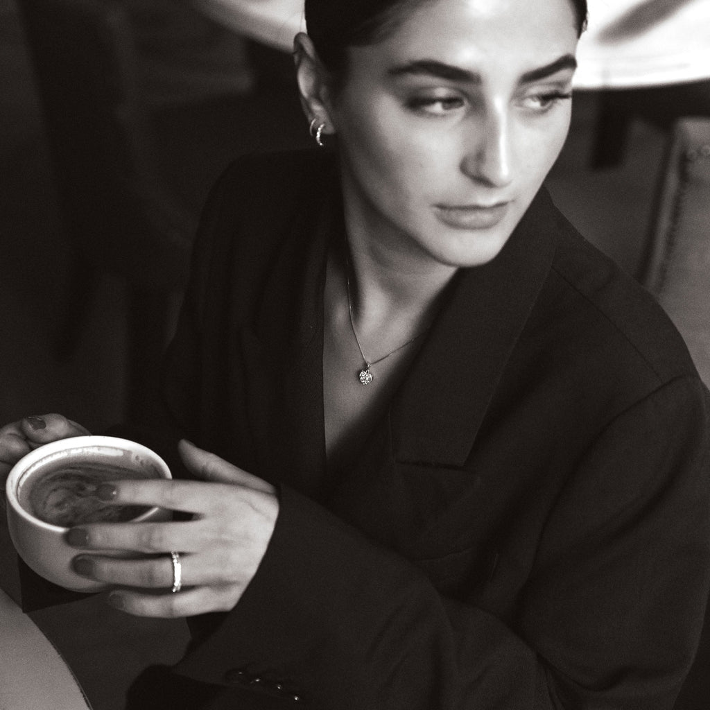 woman in caffe wearing diamond jewellery