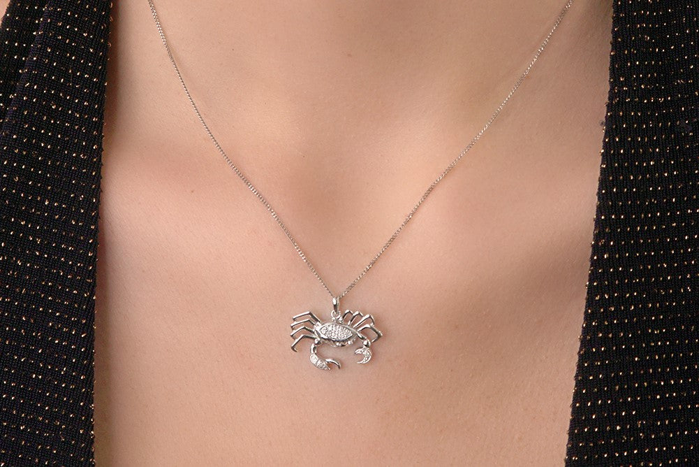 Woman wearing cancer zodiac star sign necklace