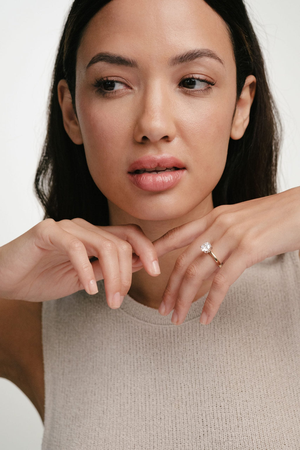 woman wearing solitaire ring