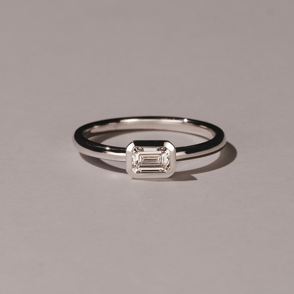 east-west setting emerald cut diamond engagement ring