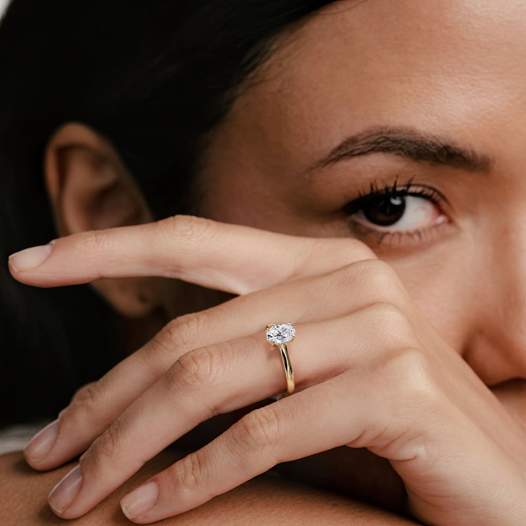 woman with an oval cut diamond ring