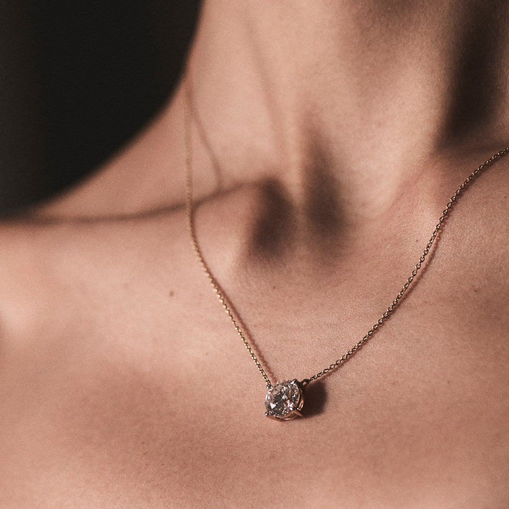 woman wearing diamond pendant