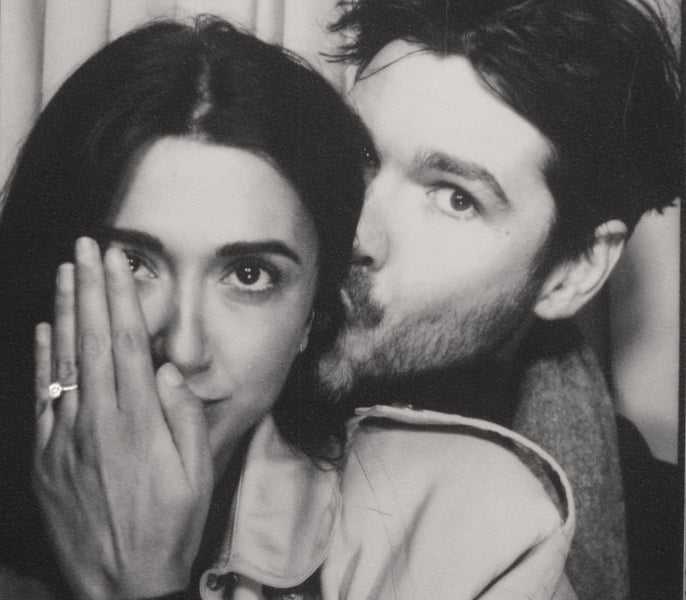 Couple showing engagement ring