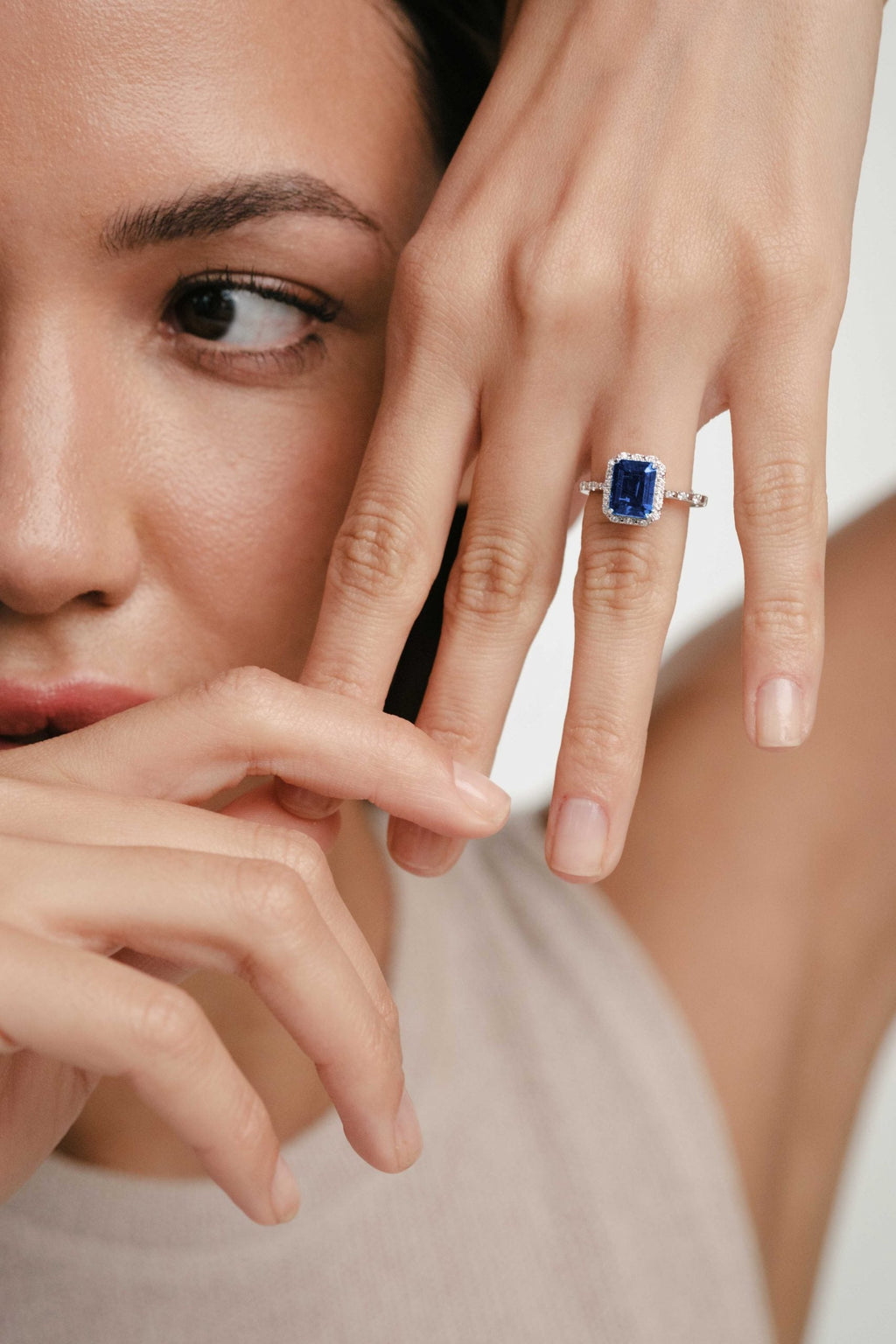 woman with gemstone and diamonds ring