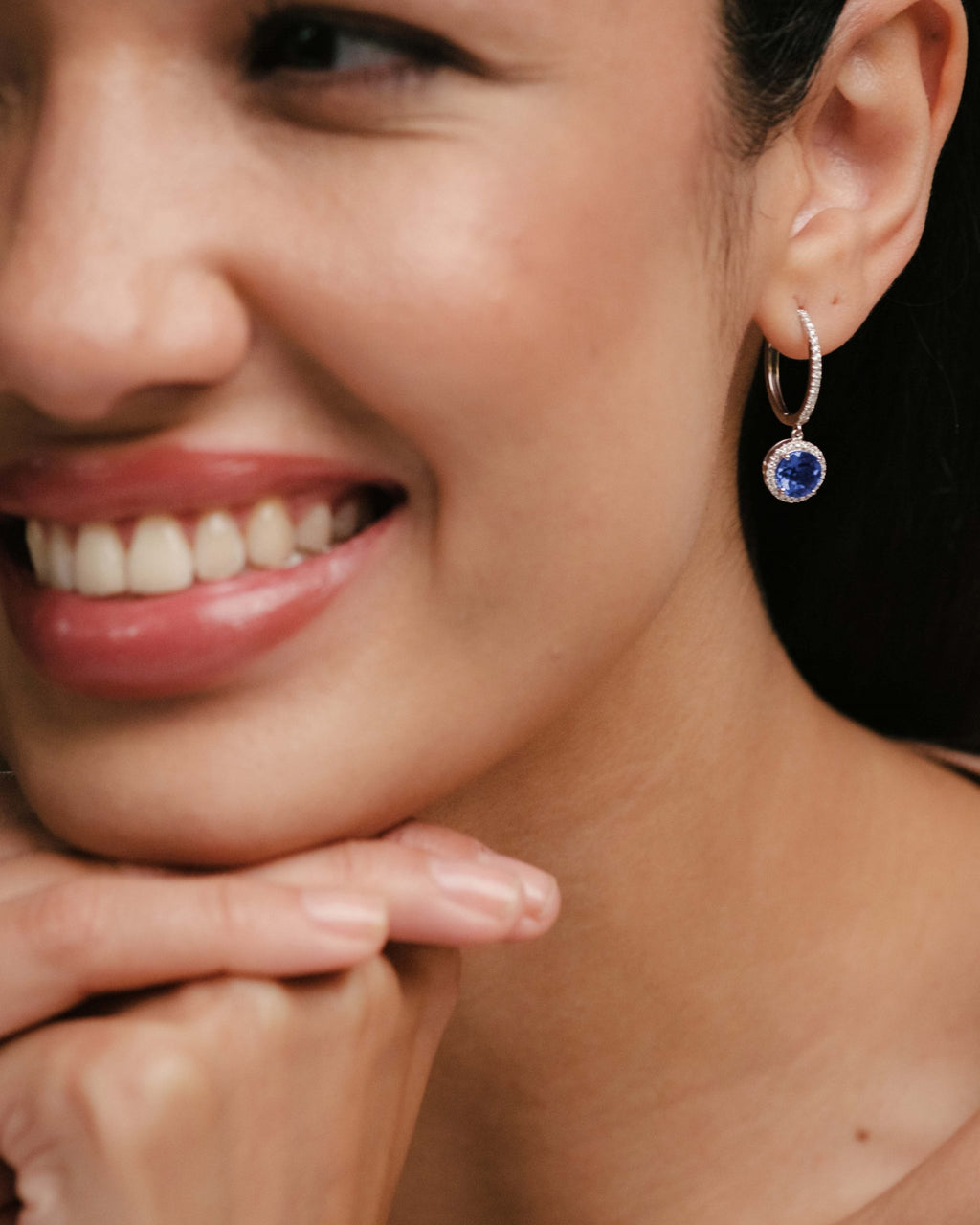 woman with sapphire and diamonds earrings