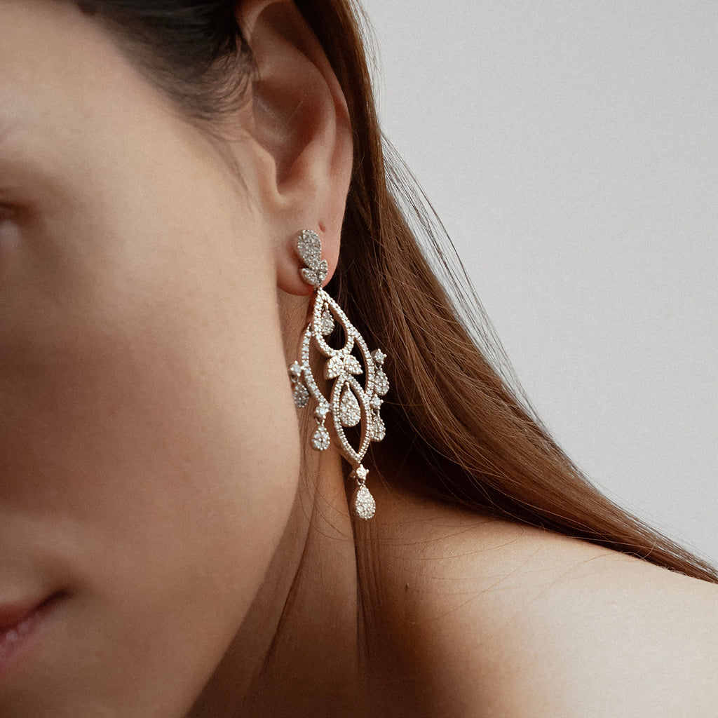 woman wearing chandelier diamond earrings