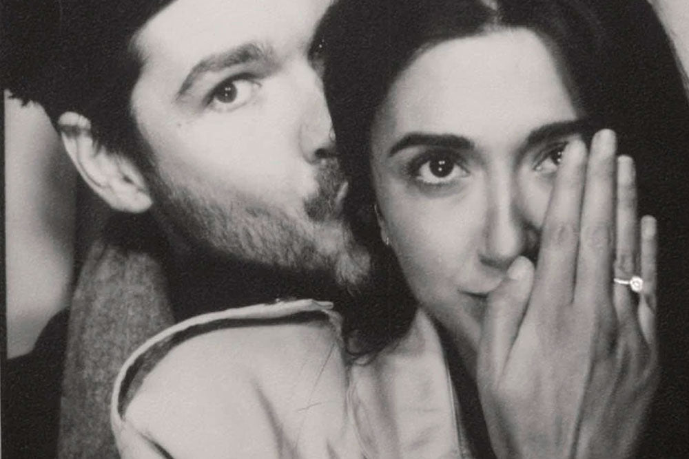 Couple showing engagement ring