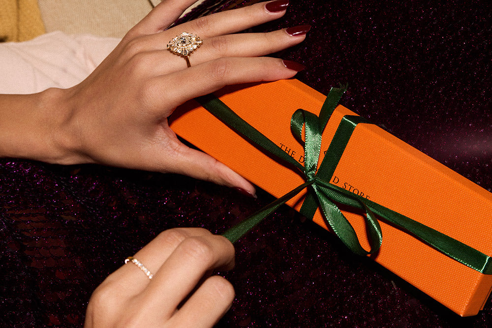woman unwrapping christmas jewellery gift