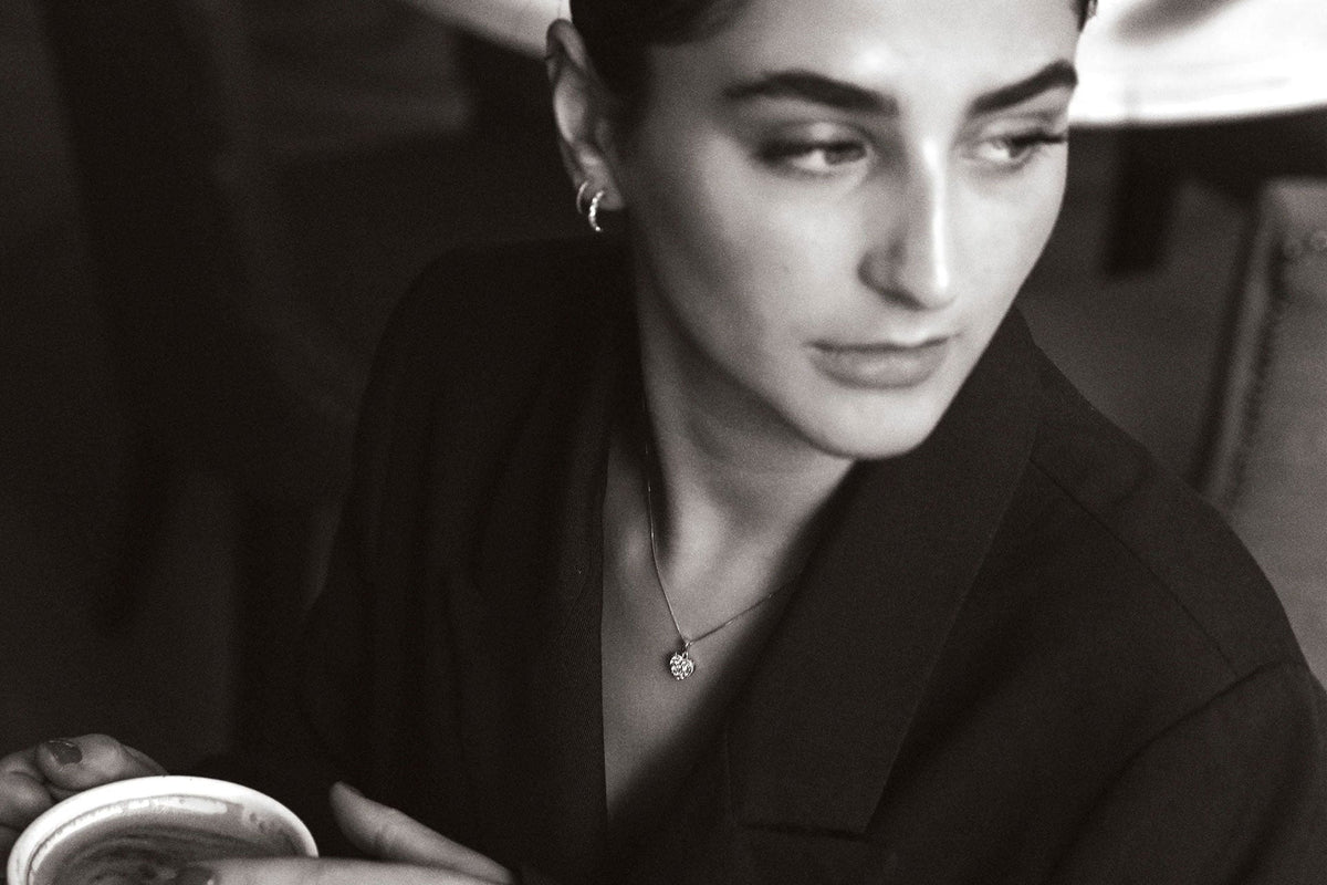 woman in caffe wearing diamond jewellery