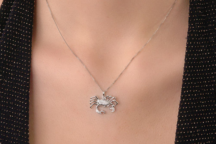 Woman wearing cancer zodiac star sign necklace