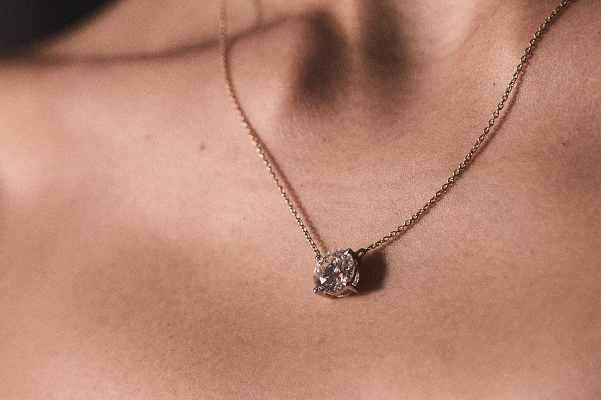 woman wearing diamond pendant