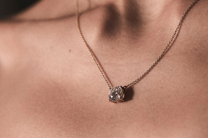 woman wearing diamond pendant