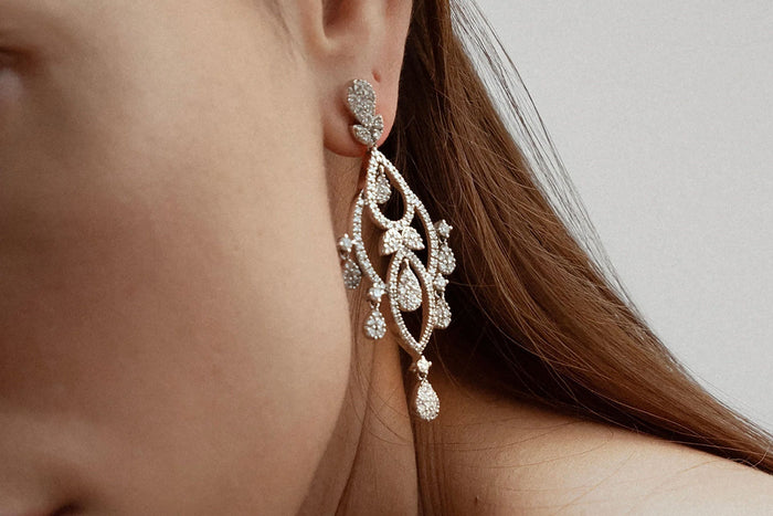 woman wearing chandelier diamond earrings