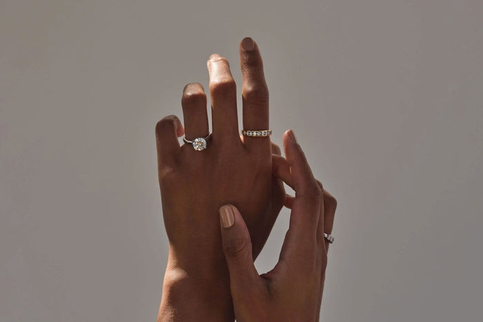 raising hands wearing jewellery