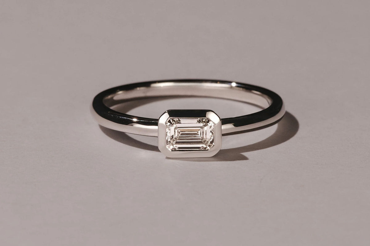 east-west setting emerald cut diamond engagement ring