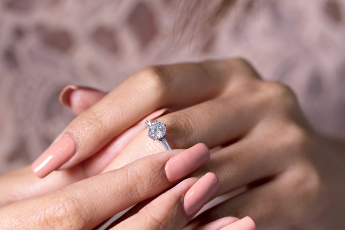 woman's hands showing an engagement ring