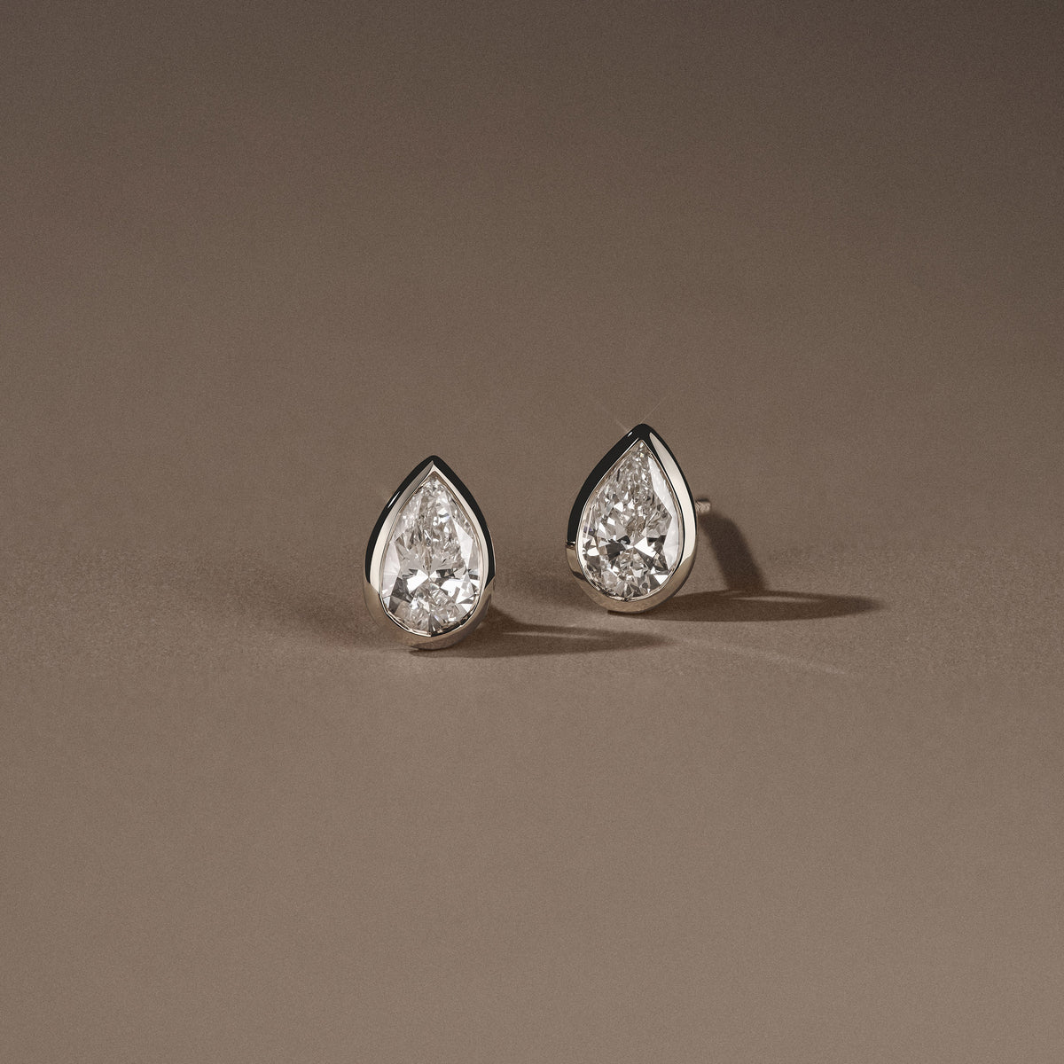Bezel Set 1.00ct Pear Cut Lab Diamond Stud Earrings in Platinum