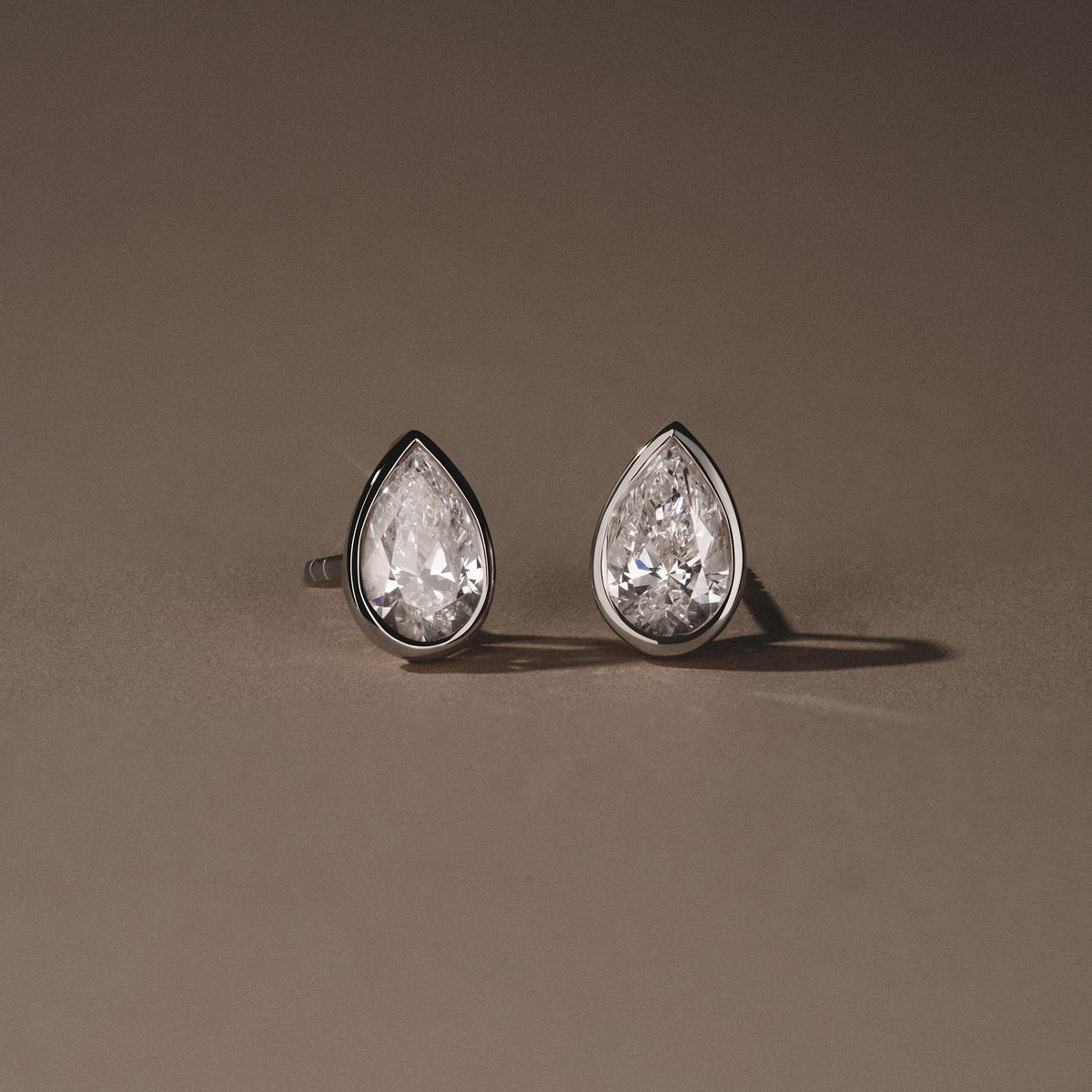 Bezel Set 2.00ct Pear Cut Lab Diamond Stud Earrings in 18K White Gold