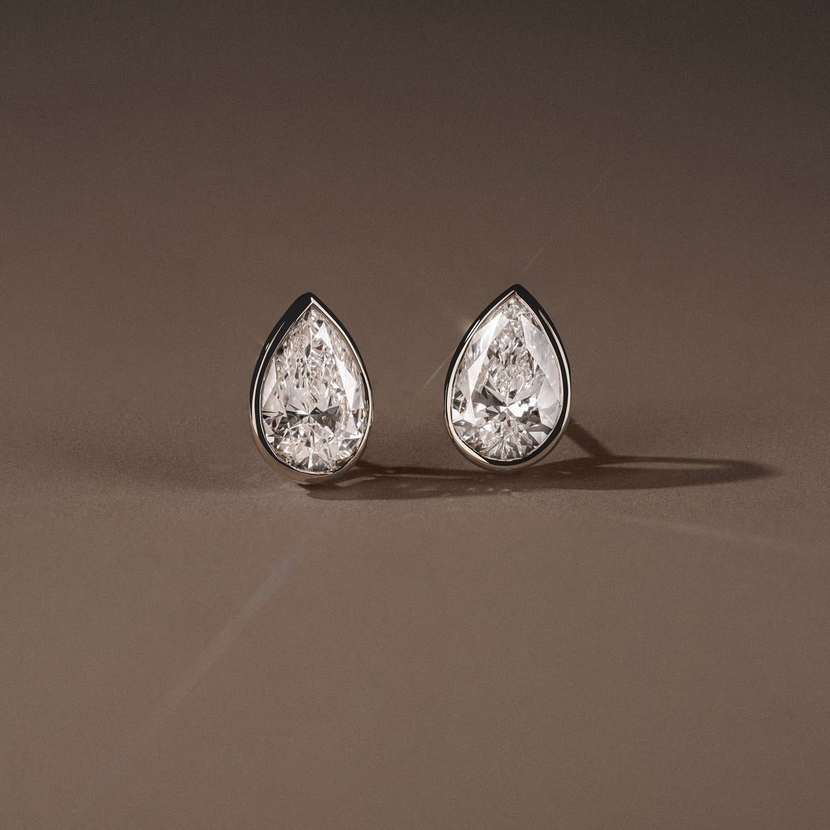 Bezel Set 3.00ct Pear Cut Lab Diamond Stud Earrings in Platinum