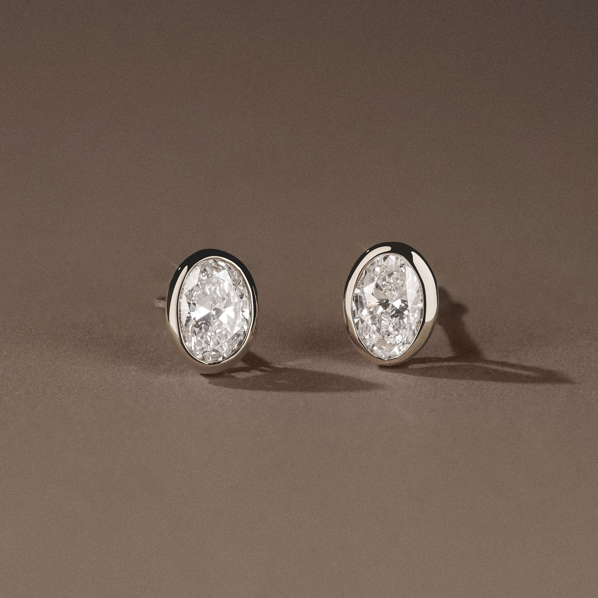 Bezel Set 1.00ct Oval Cut Lab Diamond Stud Earrings in Platinum
