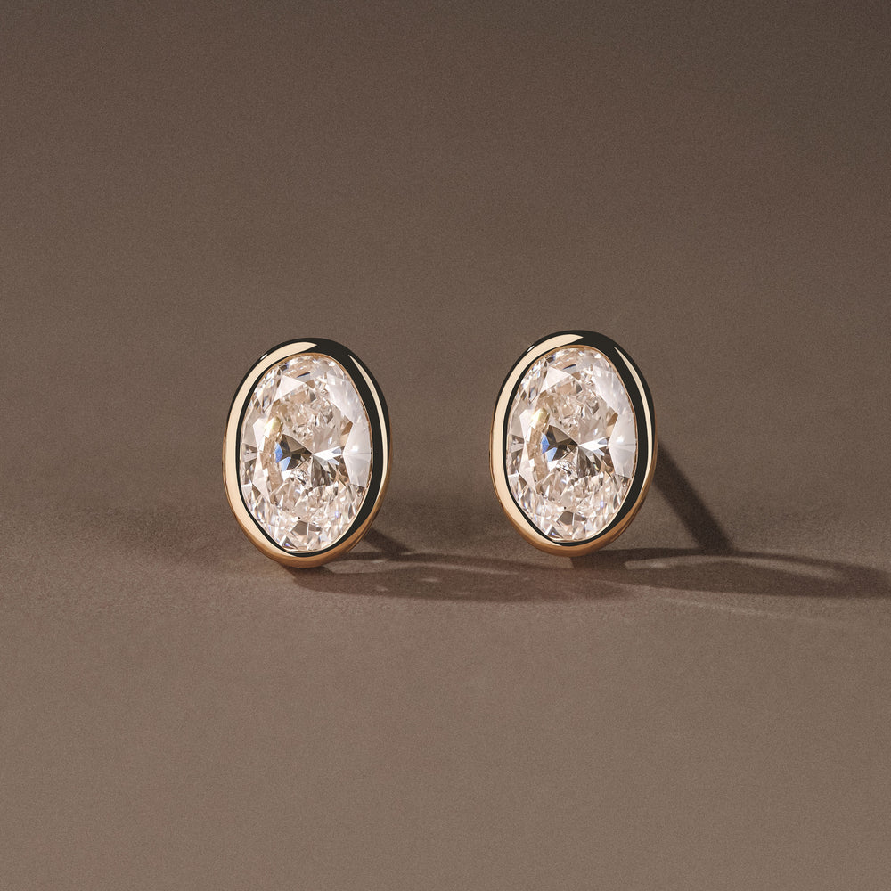 Bezel Set 2.00ct Oval Cut Lab Diamond Stud Earrings in 18K Yellow Gold