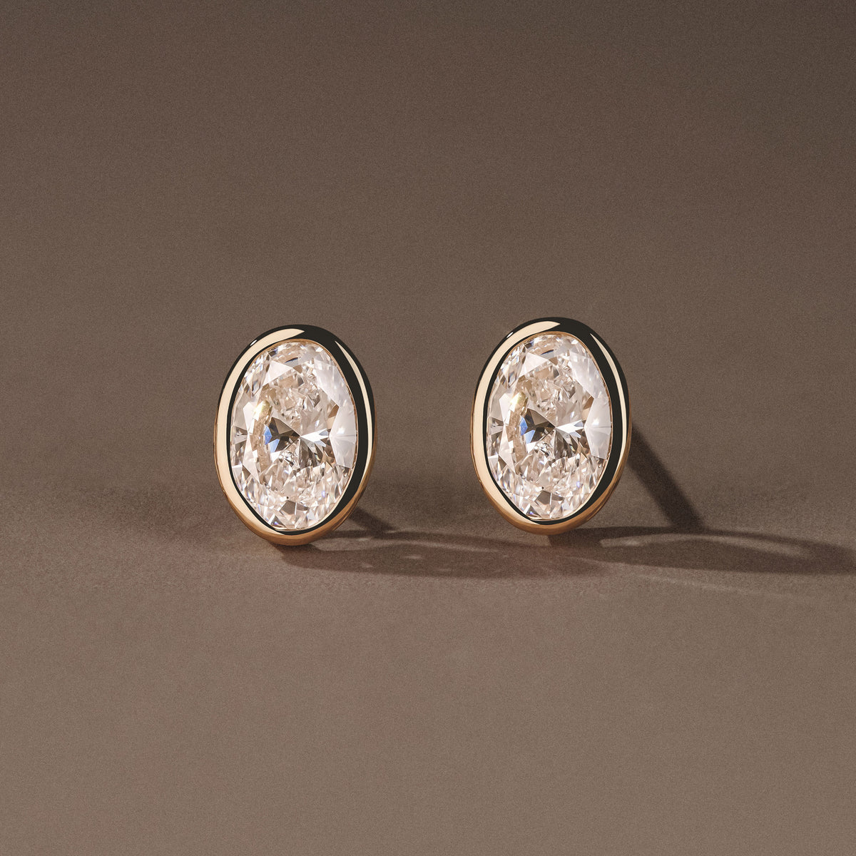 Bezel Set 2.00ct Oval Cut Lab Diamond Stud Earrings in 18K Yellow Gold