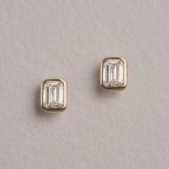 Skyline Bezel Set 1.00ct Emerald Cut Lab Diamond Stud Earrings in 18K Yellow Gold