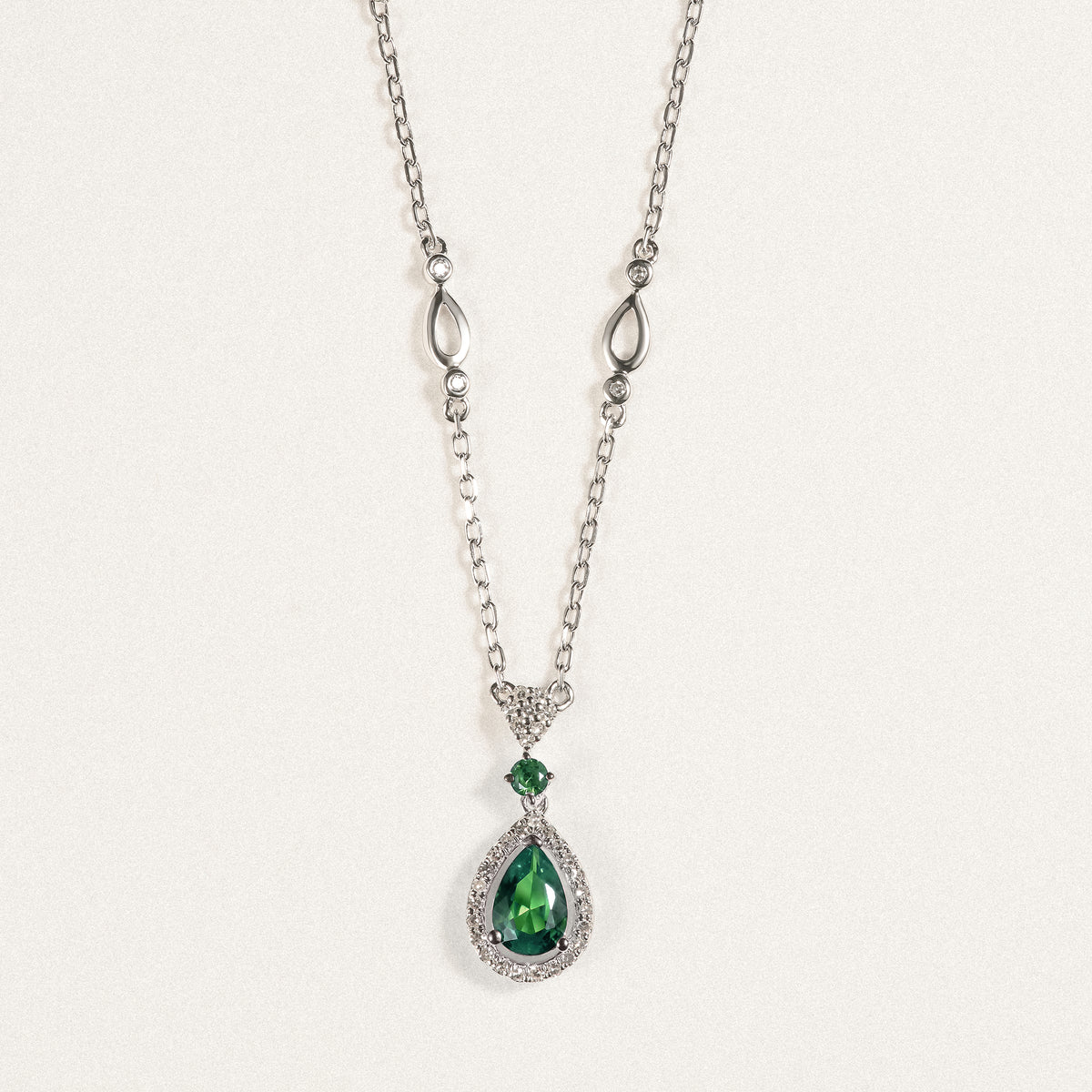 Stellato 0.33ct Pear Cut Lab Emerald Halo Pendant Necklace in Sterling Silver