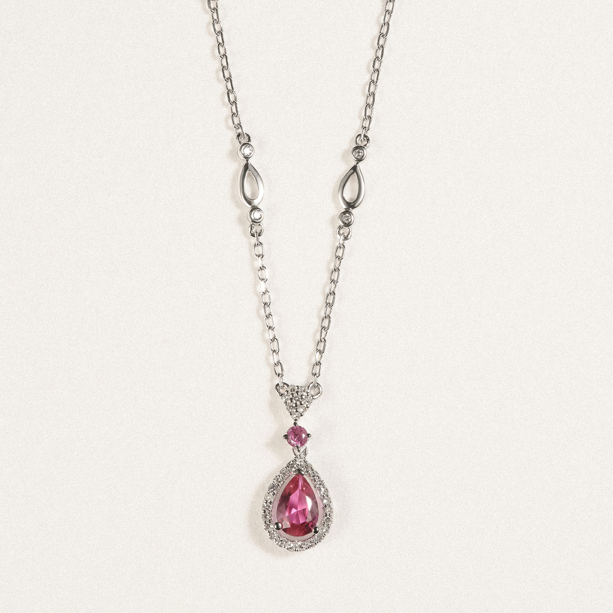 Stellato 0.50ct Pear Cut Lab Ruby Halo Pendant Necklace in Sterling Silver