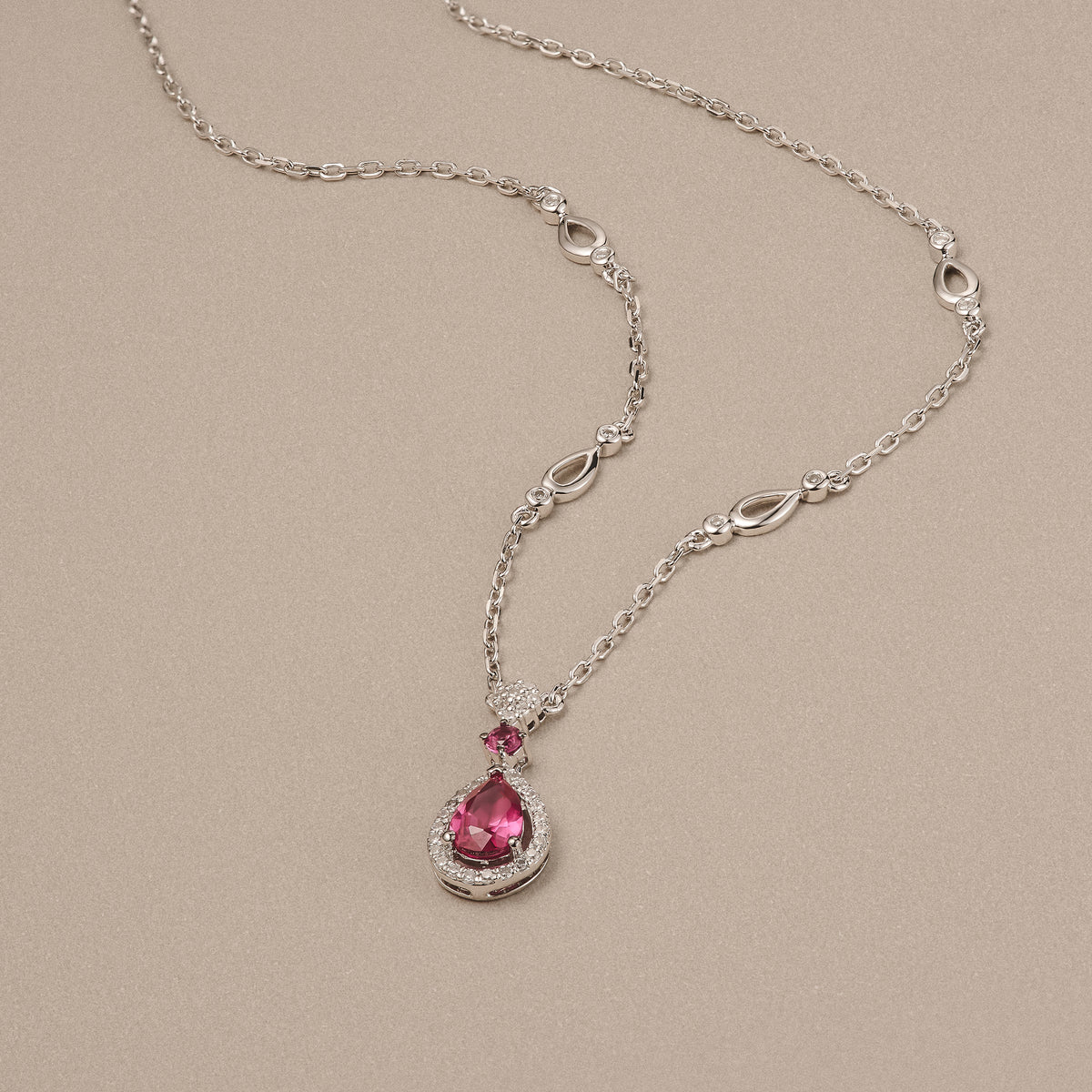 Stellato 0.50ct Pear Cut Lab Ruby Halo Pendant Necklace in Sterling Silver