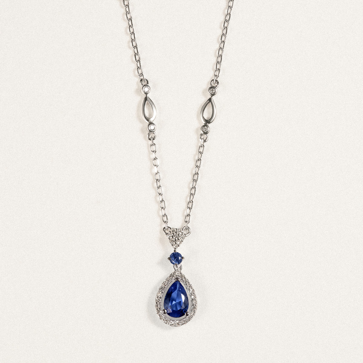 Stellato 0.60ct Pear Cut Lab Sapphire Halo Pendant Necklace in Sterling Silver