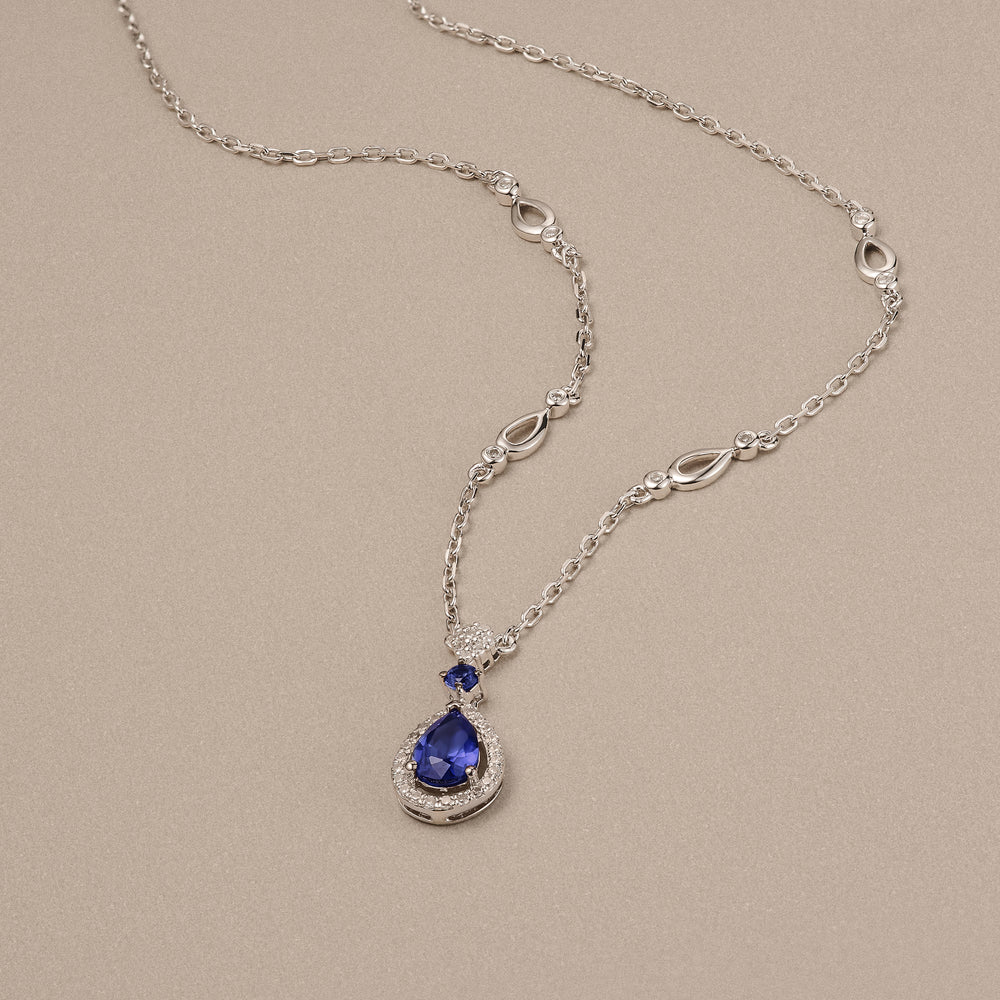 Stellato 0.60ct Pear Cut Lab Sapphire Halo Pendant Necklace in Sterling Silver