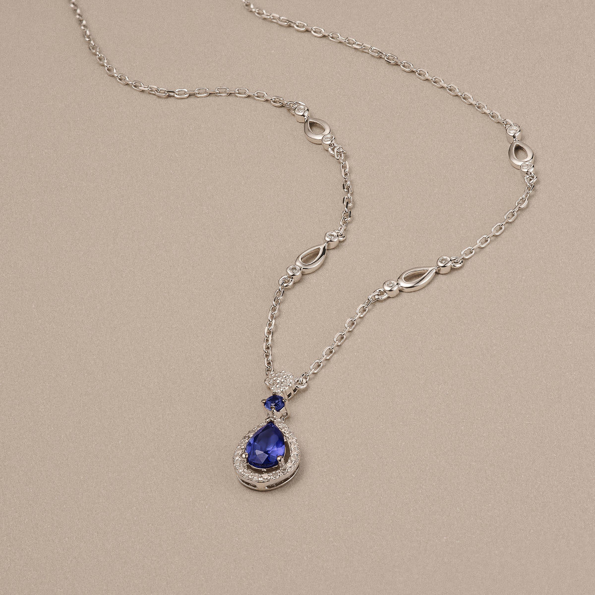 Stellato 0.60ct Pear Cut Lab Sapphire Halo Pendant Necklace in Sterling Silver