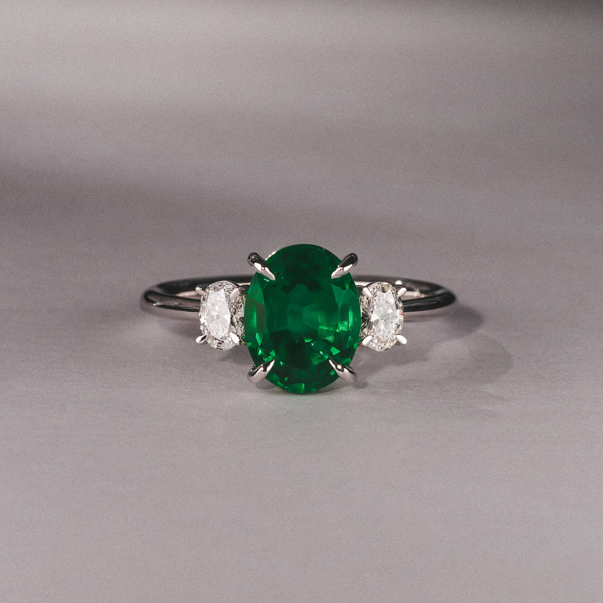 Solene 2.00ct Oval Cut Lab Emerald and Lab Diamond 3 Stone Engagement Ring in 18K White Gold