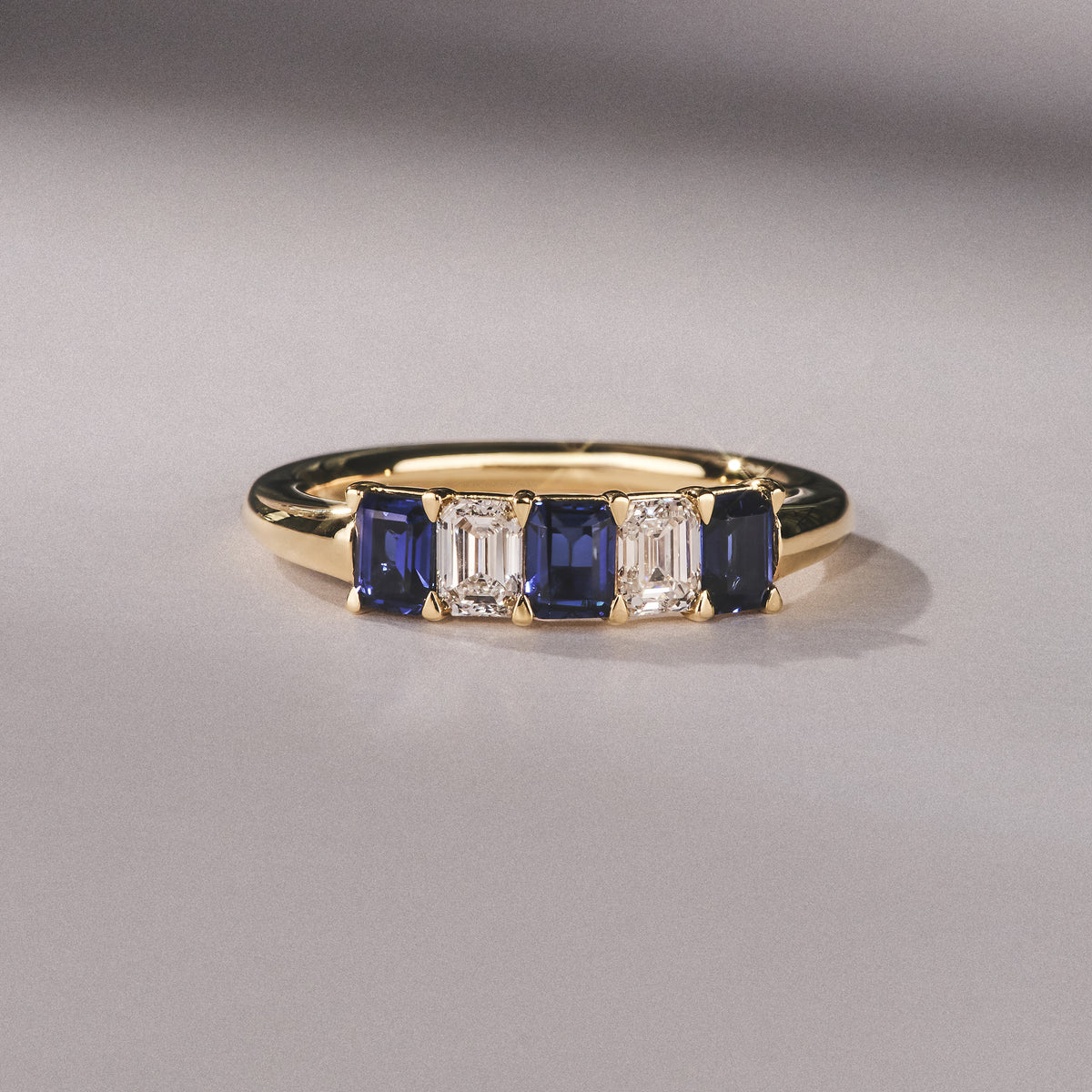 Solene 0.75ct Emerald Cut Lab Sapphire and Lab Diamond Half Band Eternity Ring in 18K Yellow Gold