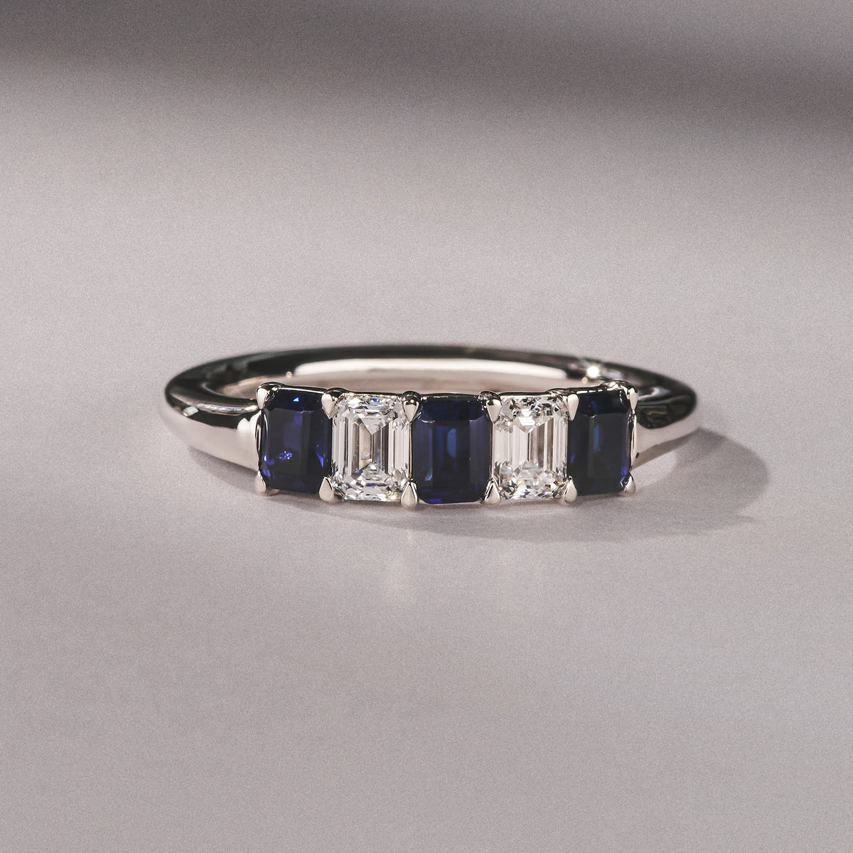 Solene 0.75ct Emerald Cut Lab Sapphire and Lab Diamond Half Band Eternity Ring in 18K White Gold