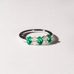 Solene 0.75ct Oval Cut Lab Emerald and Lab Diamond Half Band Eternity Ring in 18K White Gold