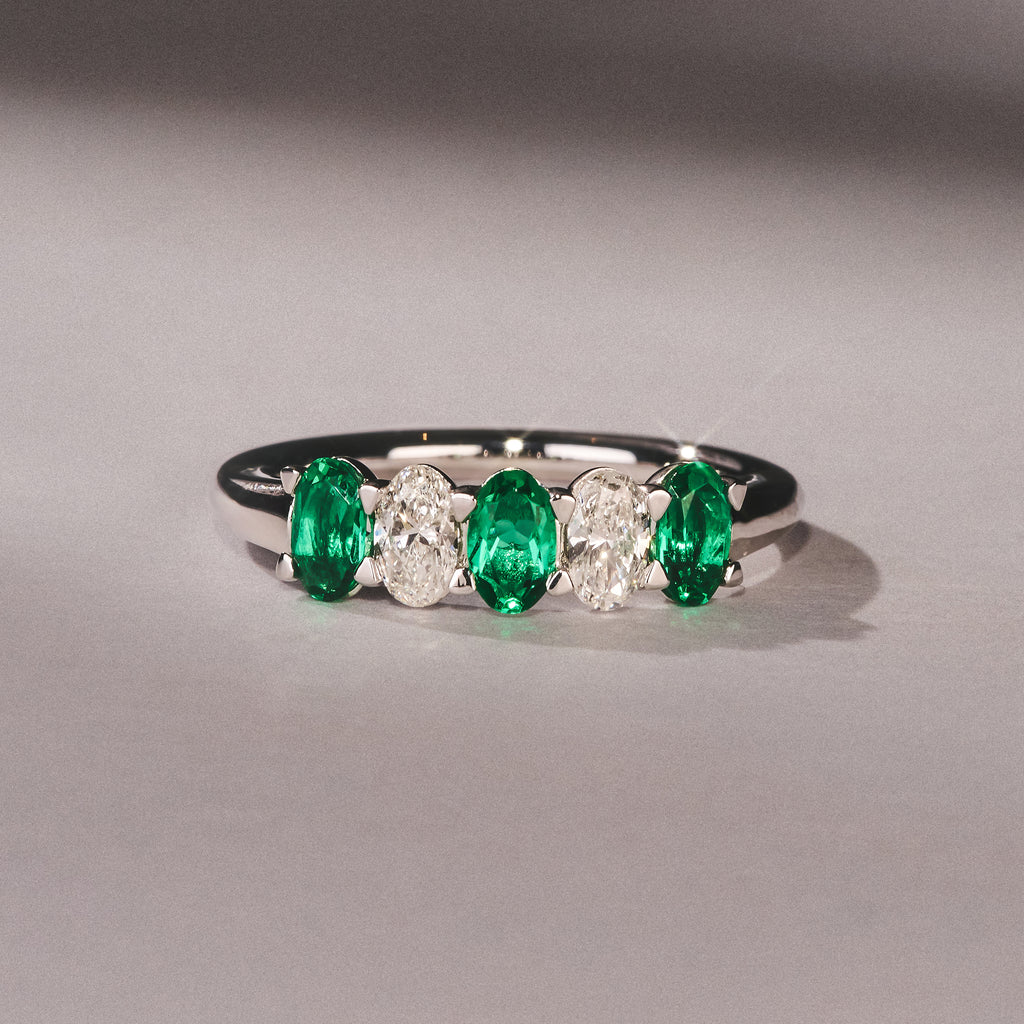 Solene 0.75ct Oval Cut Lab Emerald and Lab Diamond Half Band Eternity Ring in 18K White Gold