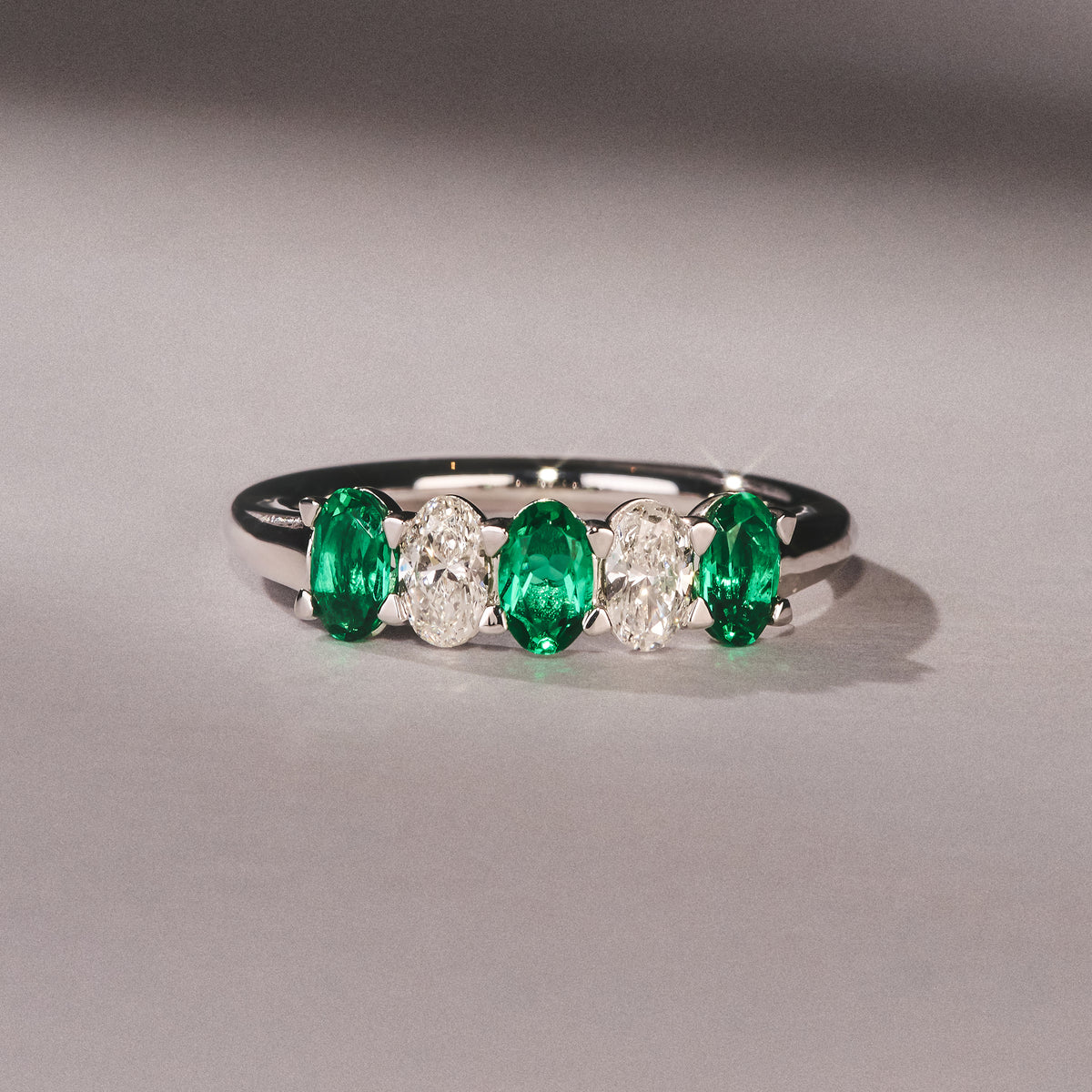 Solene 0.75ct Oval Cut Lab Emerald and Lab Diamond Half Band Eternity Ring in 18K White Gold