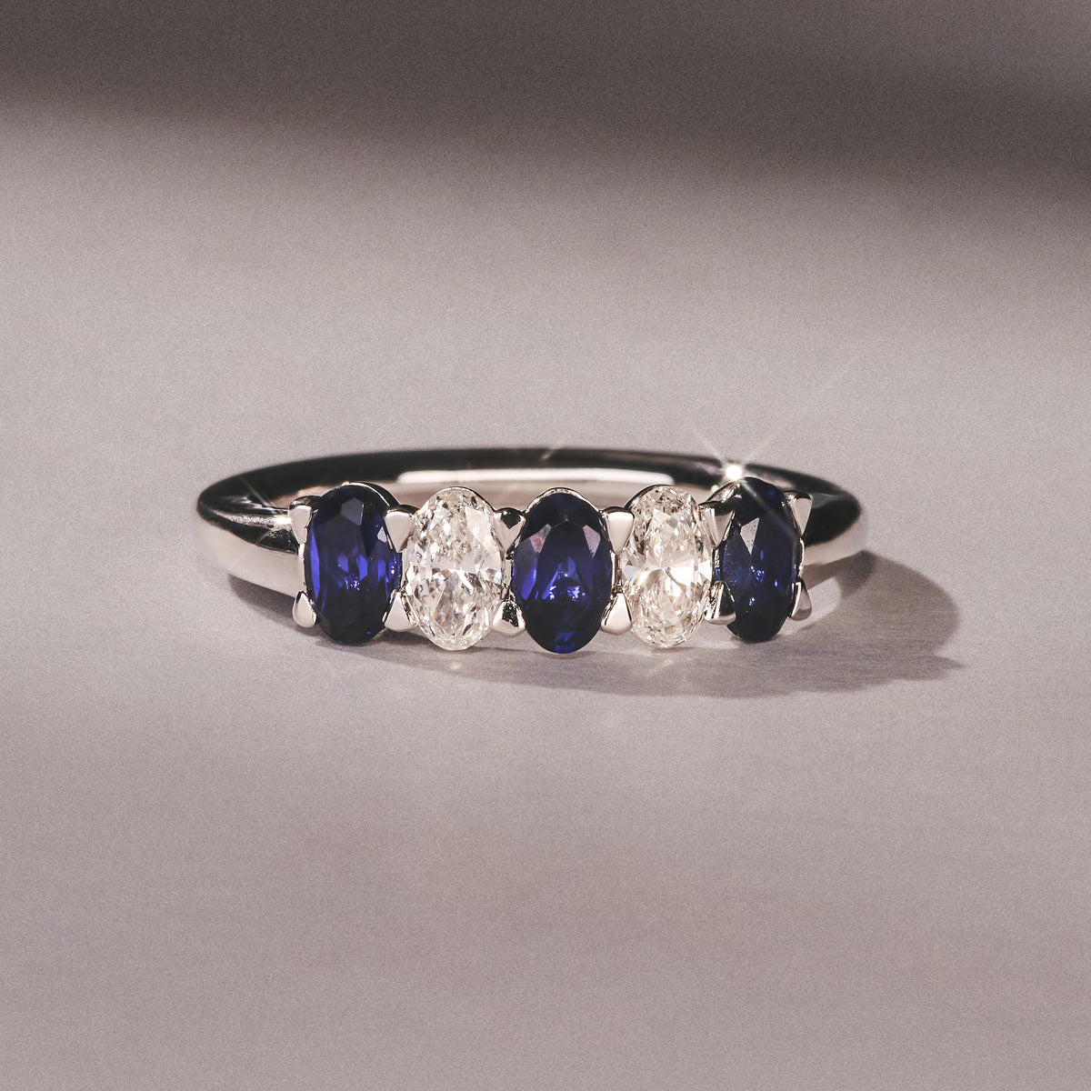 Solene 0.75ct Oval Cut Lab Sapphire and Lab Diamond Half Band Eternity Ring in 18k White Gold