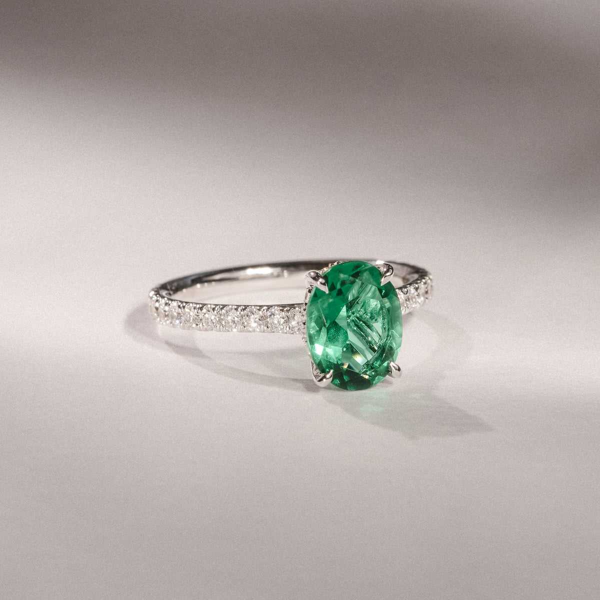 Amora Gem 2.00ct Oval Cut Lab Emerald Hidden Halo Engagement Ring with Side Stones in 18K White Gold
