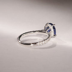Amora Gem 2.00ct Oval Cut Lab Sapphire Hidden Halo Engagement Ring with Side Stones in 18K White Gold