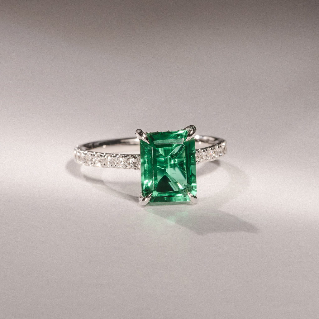 Amora Gem 2.50ct Emerald Cut Lab Emerald Hidden Halo Engagement Ring with Side Stones in 18K White Gold