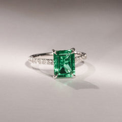 Amora Gem 2.50ct Emerald Cut Lab Emerald Hidden Halo Engagement Ring with Side Stones in 18K White Gold