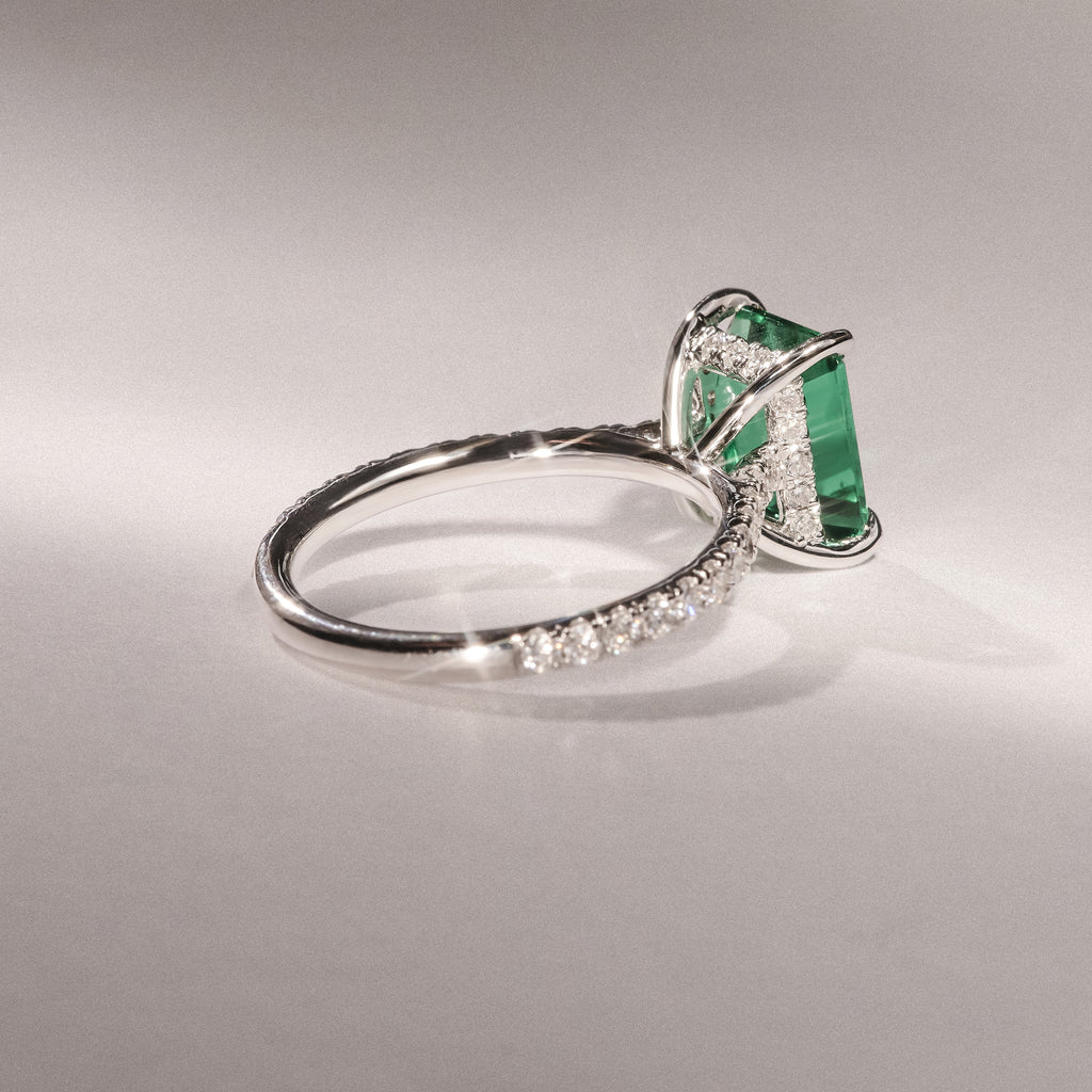 Amora Gem 2.50ct Emerald Cut Lab Emerald Hidden Halo Engagement Ring with Side Stones in 18K White Gold