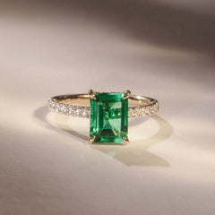 Amora Gem 2.00ct Emerald Cut Lab Emerald Hidden Halo Engagement Ring with Side Stones in 18K Yellow Gold