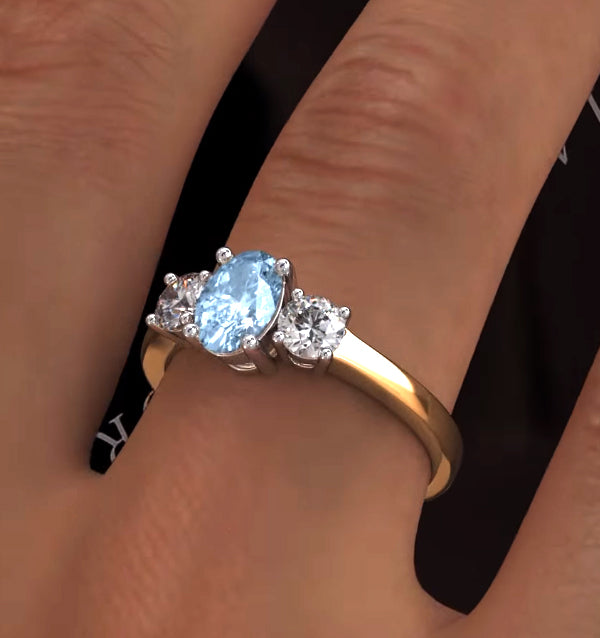 0.70ct Oval Cut Aquamarine and Lab Diamond 3 Stone Ring in 9K Yellow Gold